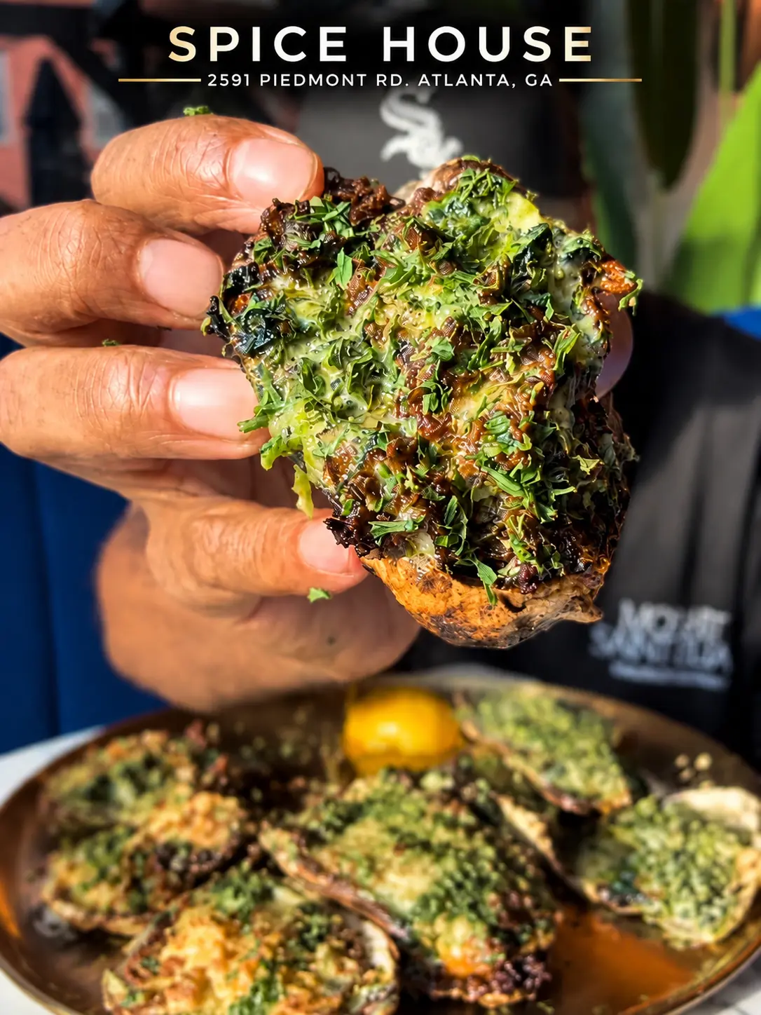 Garlic Herb char-grilled oyster with garlic-herb butter, Parmesan and fresh herbs at Spice House Buckhead